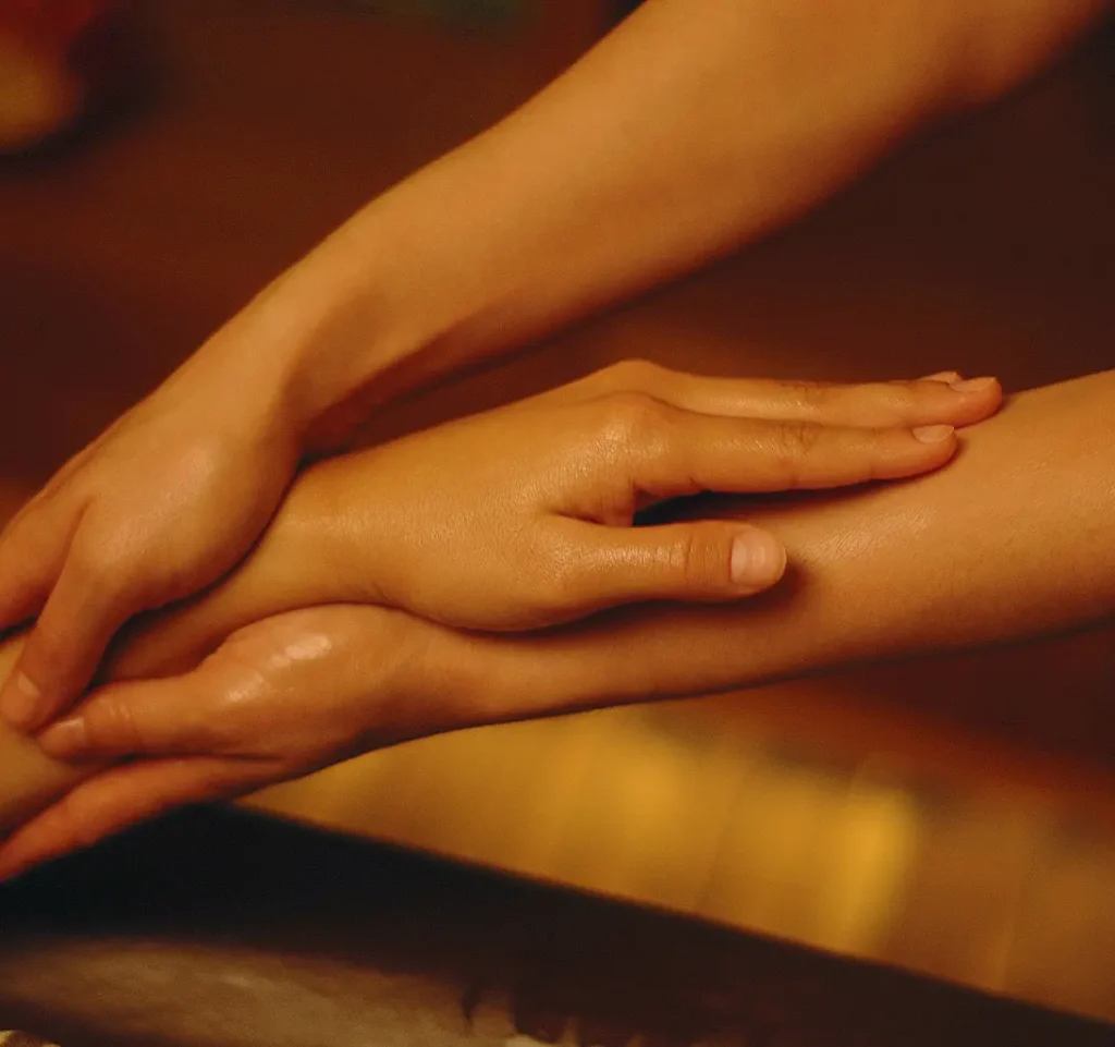 Friendly masseuse preparing linens for best outcall massage Bangkok session.